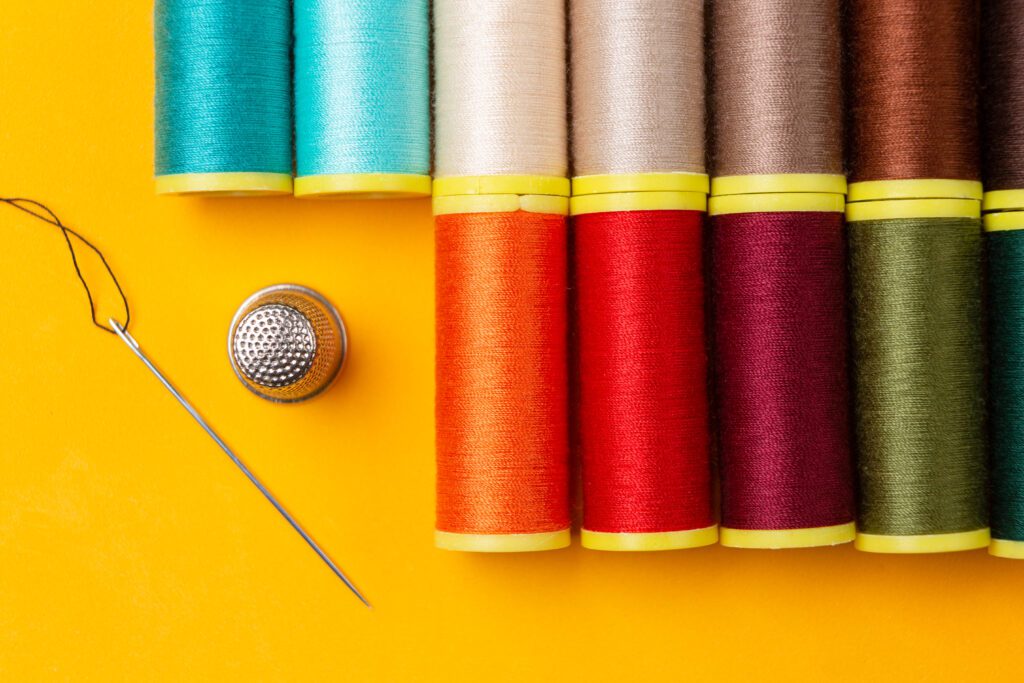 Sewing threads and a needle thimble